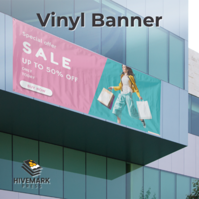 Custom vinyl banner with full color print displayed outdoors on wall with grommets